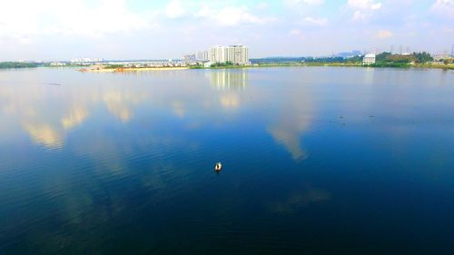 Scenic view of river against sky in city