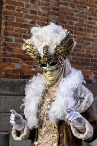 Close-up of person wearing venetian mask 