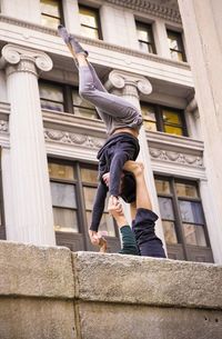 Low angle view of man standing against building