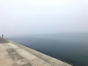 Scenic view of sea against sky during foggy weather