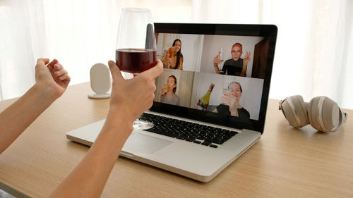 Woman talking on video chat with friends