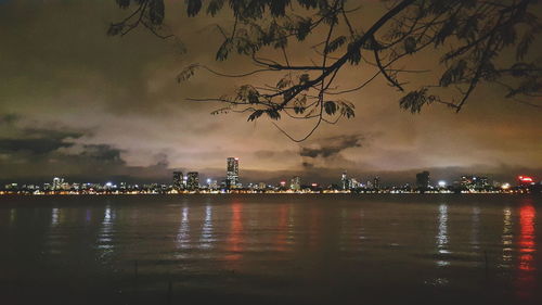 Illuminated city at waterfront