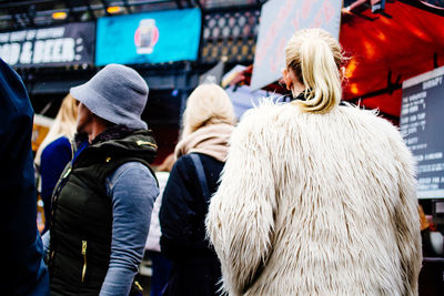 Rear view of woman wearing fur coat