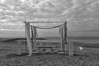 Lifeguard hut on beach against sky