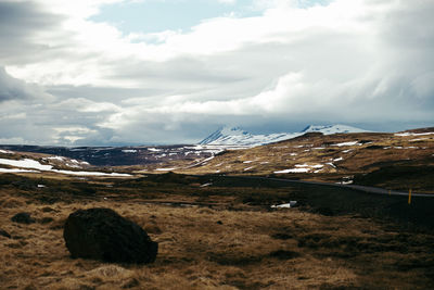 Scenic view of mountains against cloudy sky