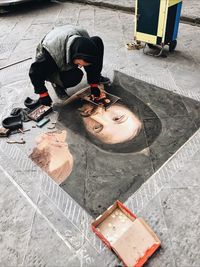 High angle view of girl standing on sidewalk