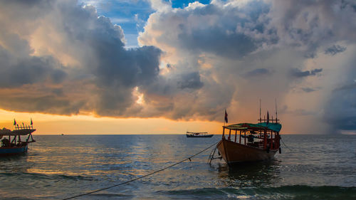 Koh rong island, cambodia at sunrise. strong vibrant colors, boats and ocean