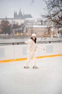 Full length of young woman standing in city