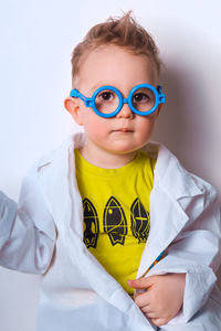 Little explorer. boy plays scientist. funny child with blue glasses. cute, colorful photo. 