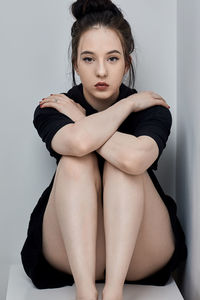 Portrait of young woman sitting outdoors