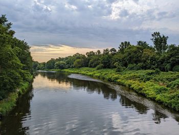 Scenic view of a channel against sky during sunrise