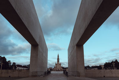 Low angle view of bridge against sky in city