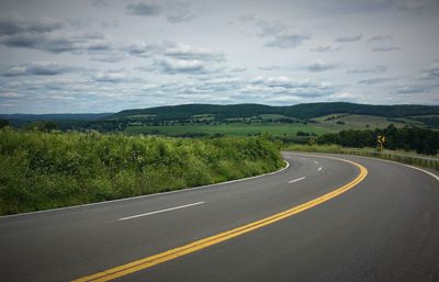 Empty road leading towards mountains