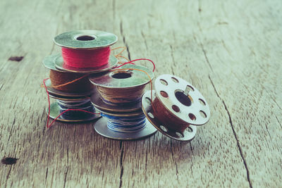 High angle view of thread spools on table