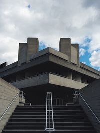 Low angle view of building against cloudy sky