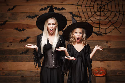 Surprised mother and daughter wearing costume