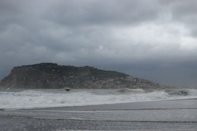 Scenic view of sea against cloudy sky