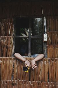 Full length of woman relaxing on wood