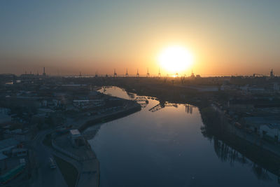 High angle view of city and buildings against sky during sunset