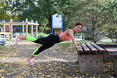 Portrait of young woman exercising in gym