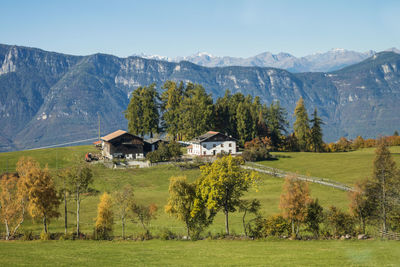 Scenic view of rural landscape and houses against sky