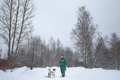 Full length of man with dogs during winter