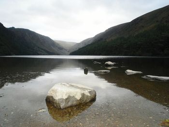 Scenic view of lake and mountains against sky