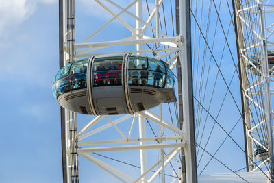 Low angle view of ferris wheel against blue sky