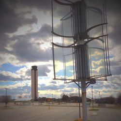 Street light against cloudy sky