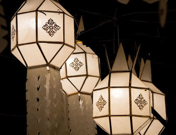 Low angle view of illuminated lanterns hanging on ceiling