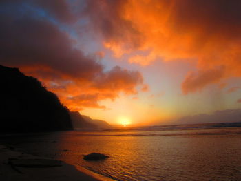 Scenic view of sea against orange sky