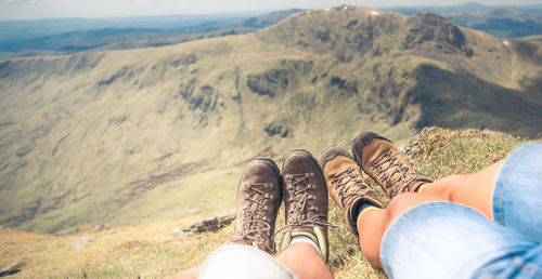 Low section of men legs against mountains