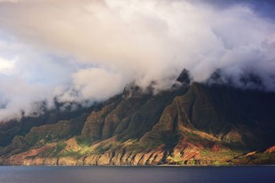 Scenic view of sea and mountains against sky