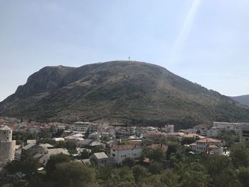 Townscape by mountain against sky