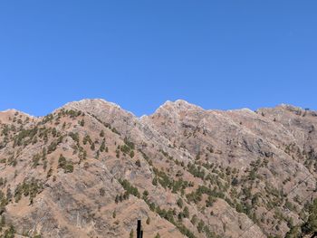 Scenic view of mountains against clear blue sky