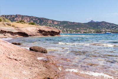 Scenic view of sea and mountains against sky