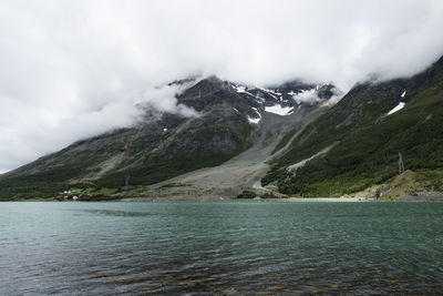 Scenic view of lake and mountains against sky