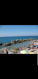 Scenic view of beach against clear blue sky