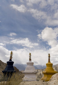 Statue of temple against cloudy sky