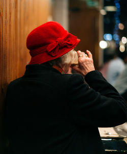 Rear view of man standing against red city