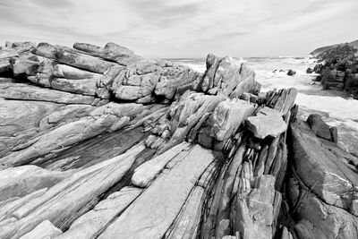 Panoramic view of rock formation on beach against sky