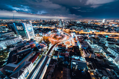 High angle view of illuminated city street against sky at night