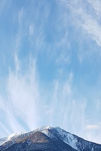 Low angle view of snowcapped mountain against sky