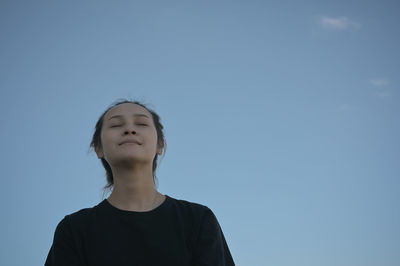 Series photo of young woman in positive emotion with blue sky