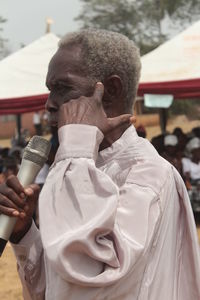 Side view of man holding microphone