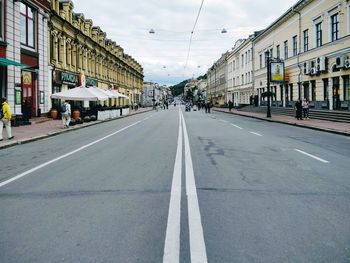 View of road amidst buildings against sky