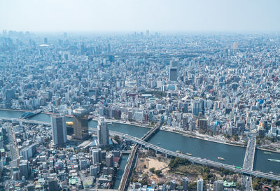 High angle view of illuminated city buildings against sky