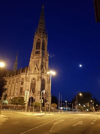 Illuminated building against sky at night