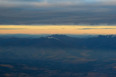 Scenic view of mountains against sky during sunset