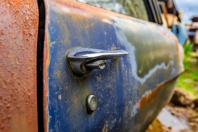 Close-up of rusty metal door of car